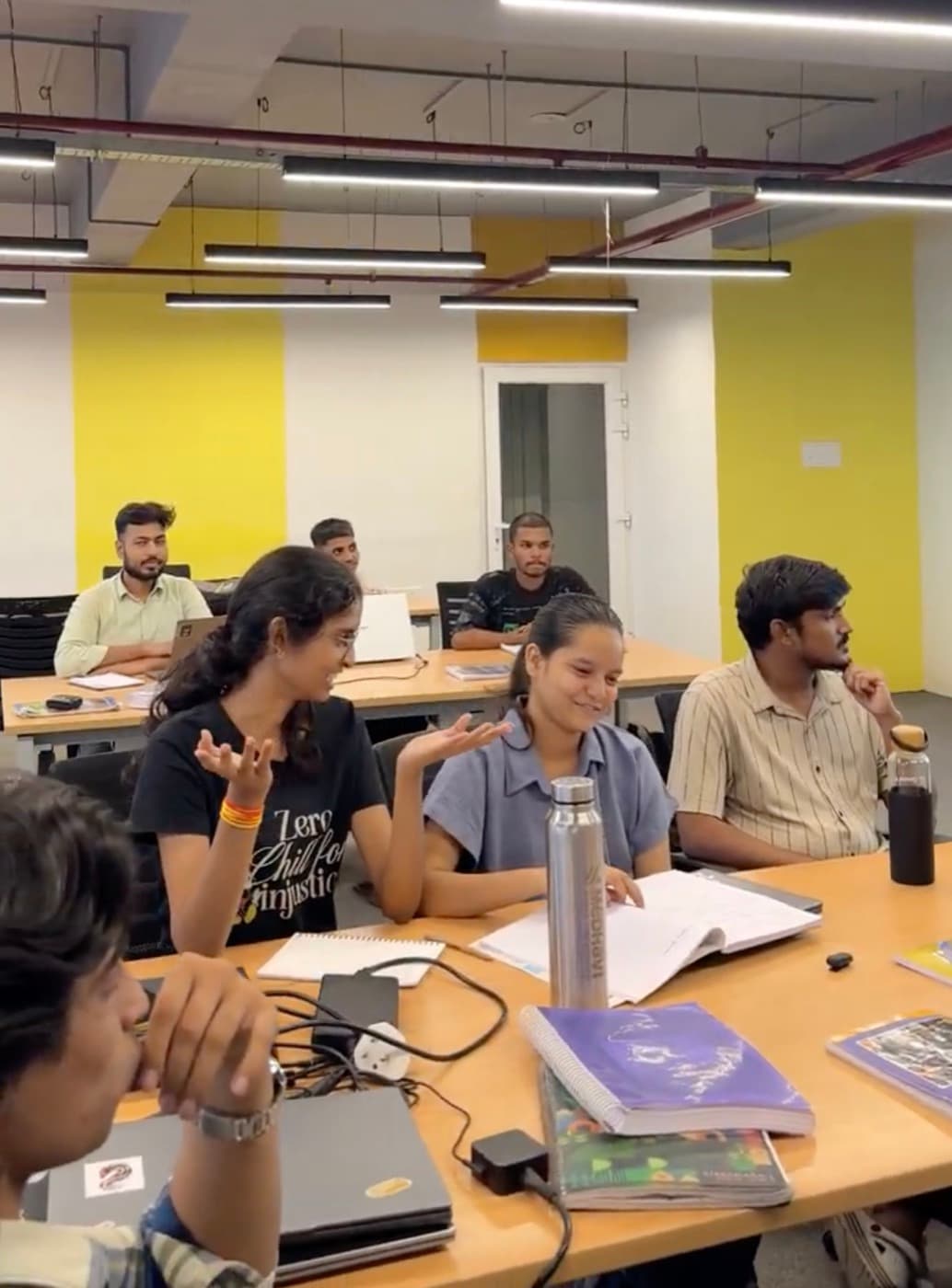 Members laughing around a table during a SpeakingLab session